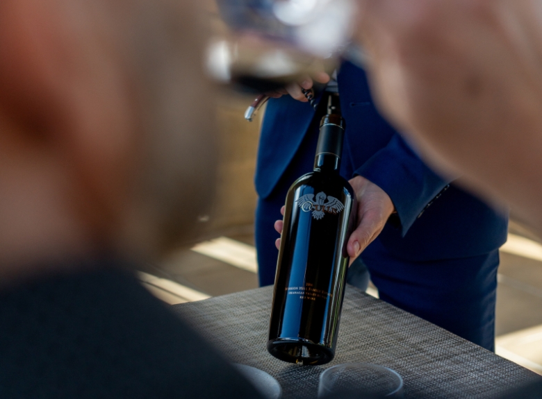 A bottle of Oculus is presented during a guided tasting at Mission Hill Family Estate Winery in West Kelowna, showcasing the estate's flagship Okanagan red blend.
