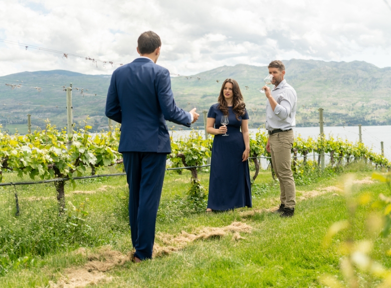 Guests explore estate vineyards with a guide at Mission Hill Family Estate Winery in West Kelowna, enjoying a winery tour experience overlooking Okanagan Lake.